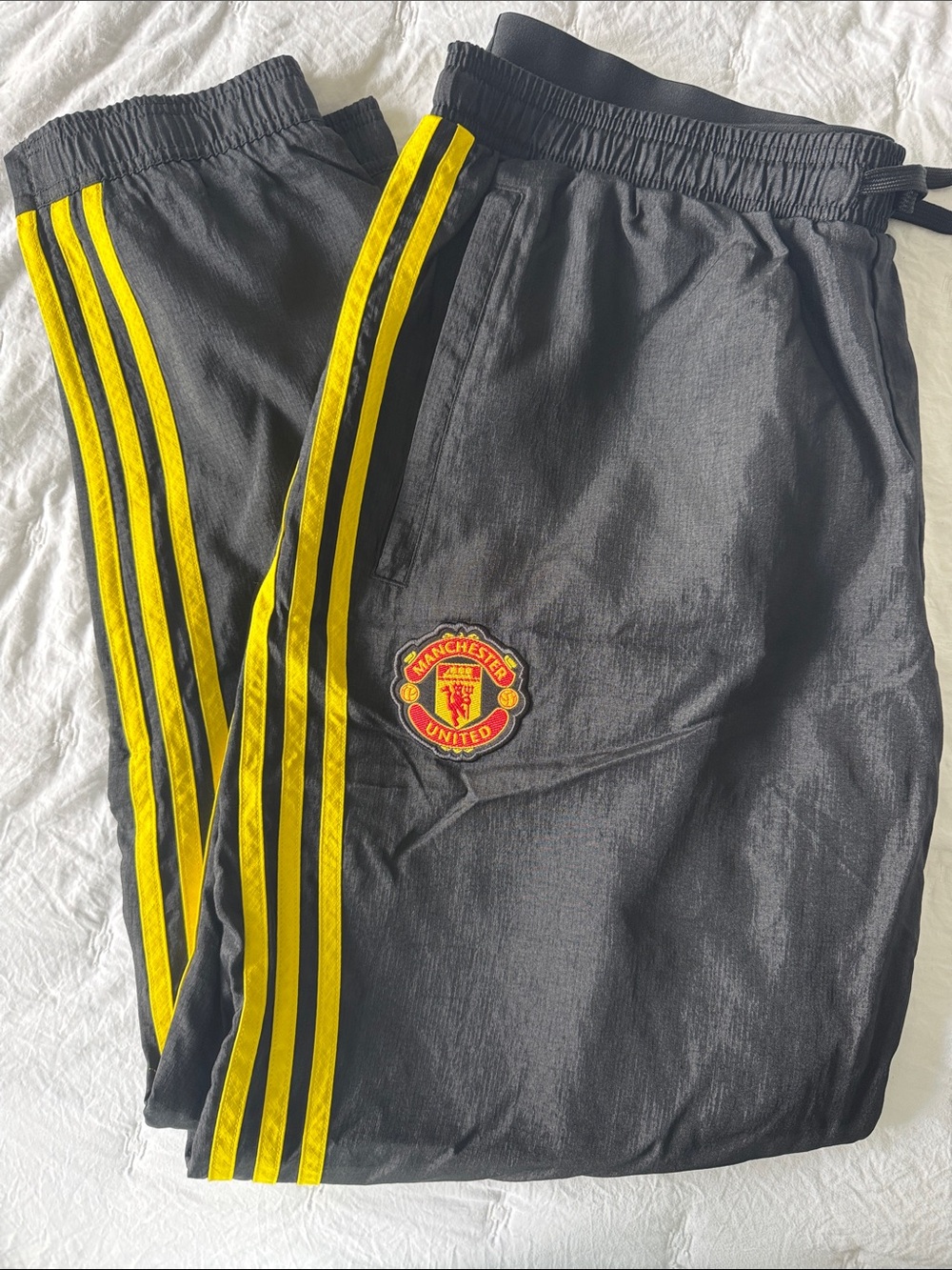 Manchester United adidas Black Joggers with Yellow Side Stripes and Blue Logo